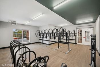 a fitness room with many bikes on a rack